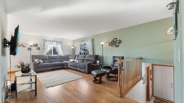 living area featuring a textured ceiling and wood finished floors