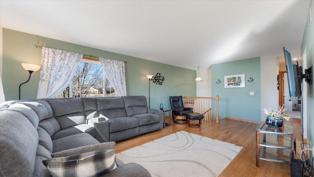 living area with wood finished floors and baseboards