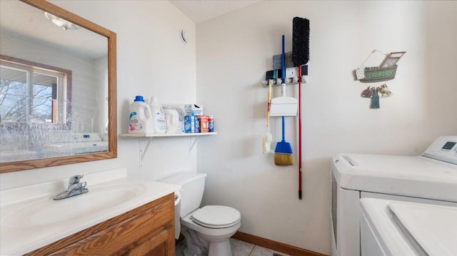 bathroom featuring toilet, baseboards, and vanity