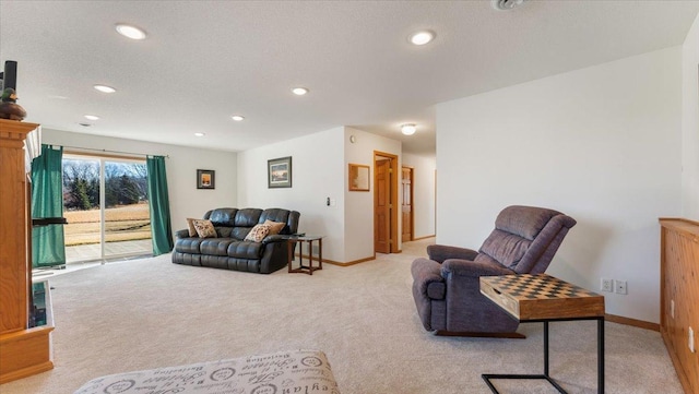 living area with carpet floors, recessed lighting, a textured ceiling, and baseboards