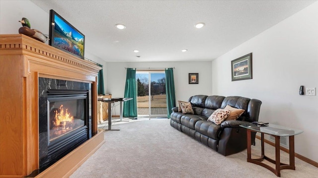 carpeted living room featuring a premium fireplace, baseboards, a textured ceiling, and recessed lighting