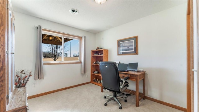 carpeted office space with baseboards, visible vents, and a textured ceiling