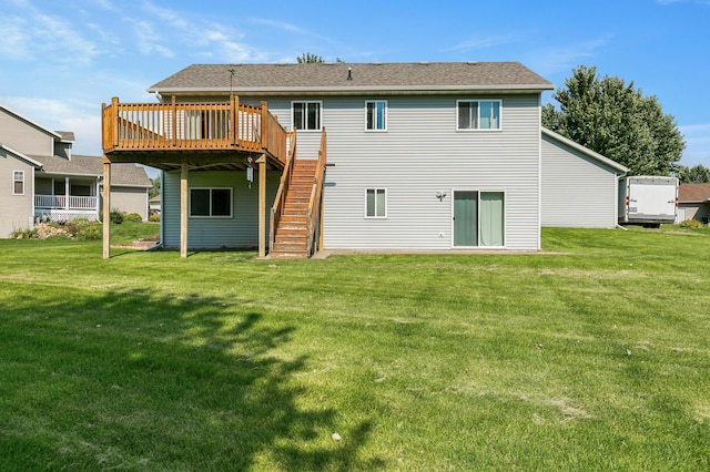 back of property with a lawn, stairway, and a wooden deck