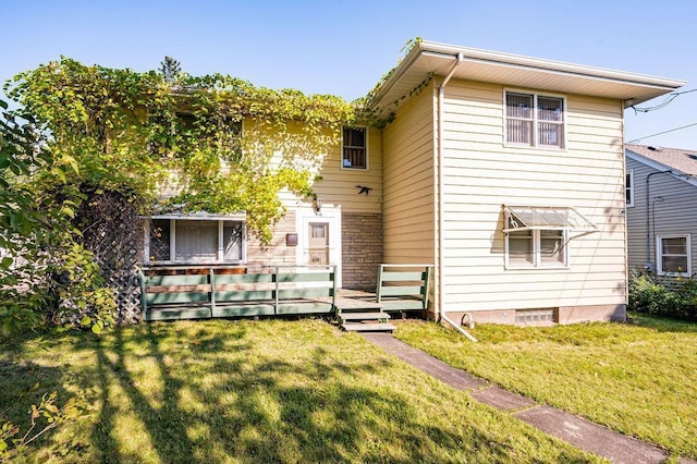back of property with a lawn