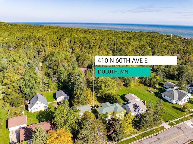 aerial view featuring a residential view and a wooded view