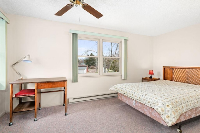 bedroom featuring carpet floors, a ceiling fan, and a baseboard heating unit