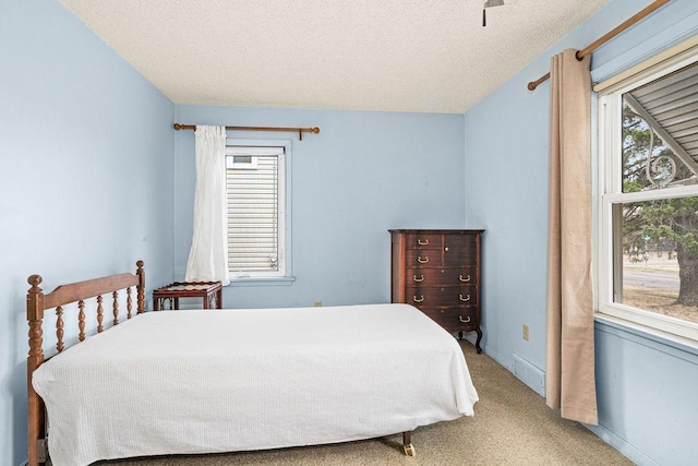 carpeted bedroom featuring visible vents and a textured ceiling