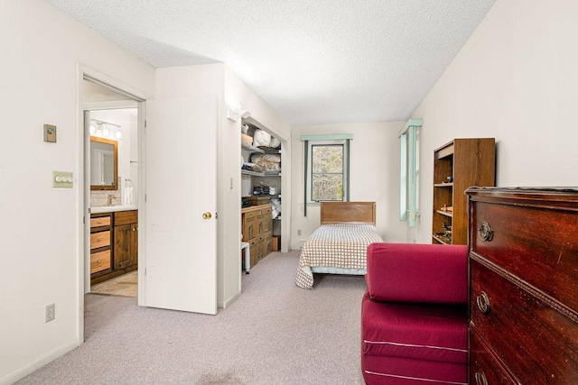 bedroom with a textured ceiling and carpet
