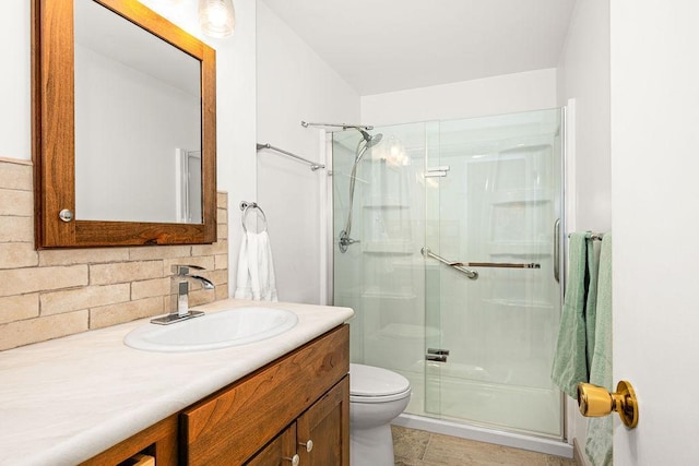 full bathroom featuring backsplash, toilet, a shower stall, and vanity