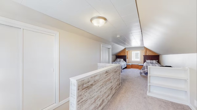 bedroom featuring vaulted ceiling and light colored carpet