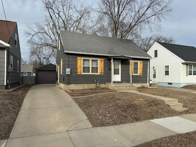 bungalow featuring an outbuilding and a garage