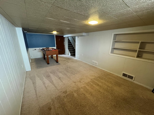 recreation room featuring carpet floors and built in shelves