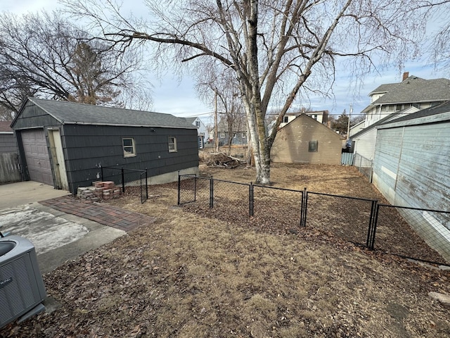 view of yard with an outbuilding, a garage, and central air condition unit