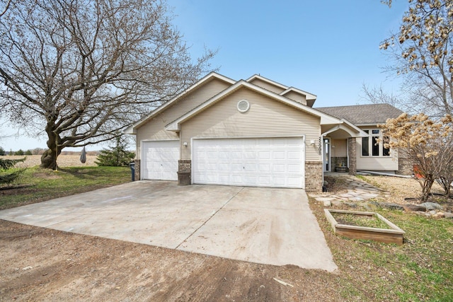 view of front of home featuring brick siding, a garage, and concrete driveway
