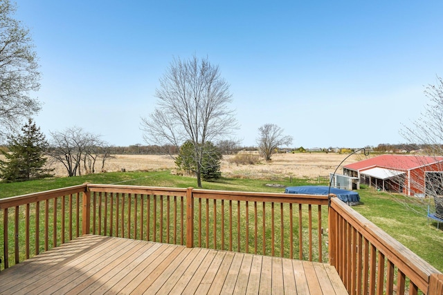 wooden terrace featuring a lawn