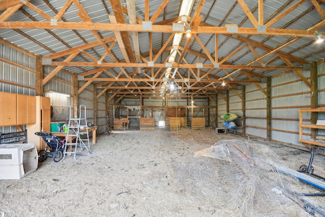 misc room featuring vaulted ceiling and metal wall