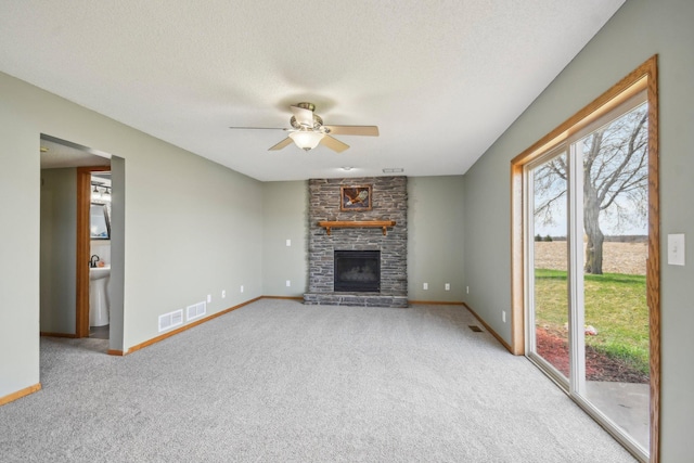 unfurnished living room with carpet floors, ceiling fan, and visible vents