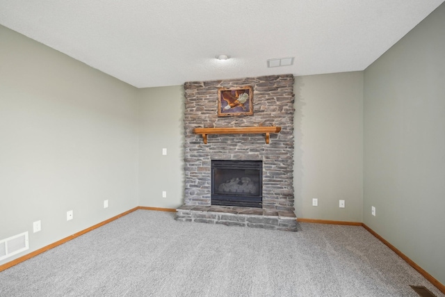 unfurnished living room with visible vents, baseboards, carpet floors, and a fireplace