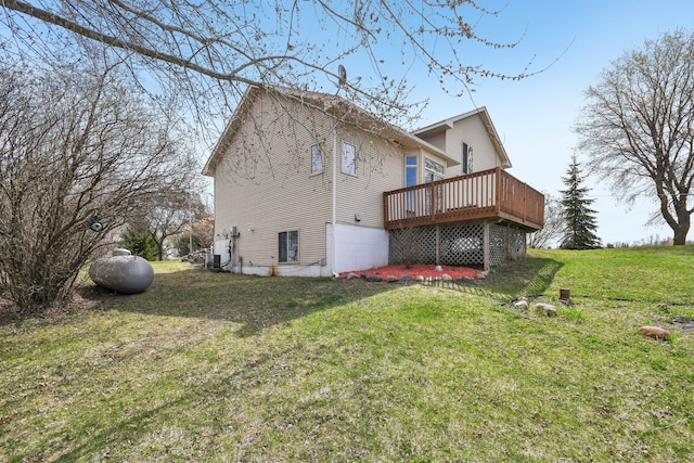 back of house featuring a lawn, a wooden deck, and central AC unit