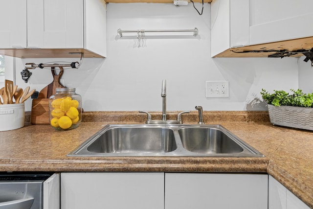 details featuring white cabinetry, dishwasher, and sink