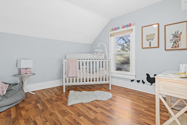 bedroom with hardwood / wood-style flooring and lofted ceiling