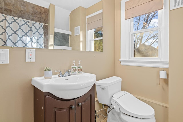 bathroom with vanity, plenty of natural light, and toilet