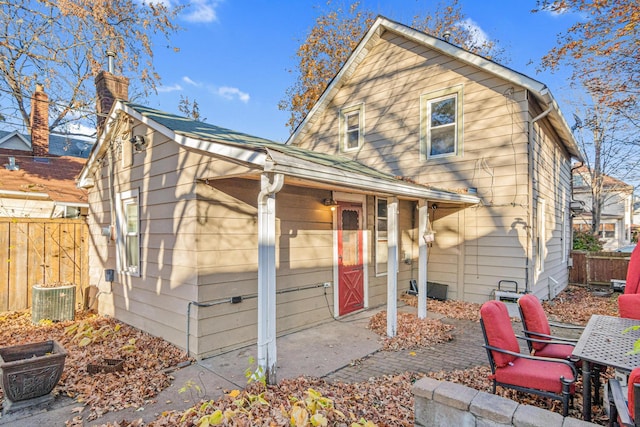 back of property featuring central AC