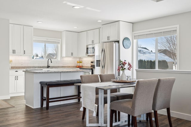 dining area featuring dark wood-style flooring, recessed lighting, and baseboards