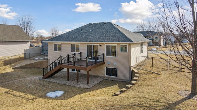 back of property with stairs, roof with shingles, fence, and a wooden deck