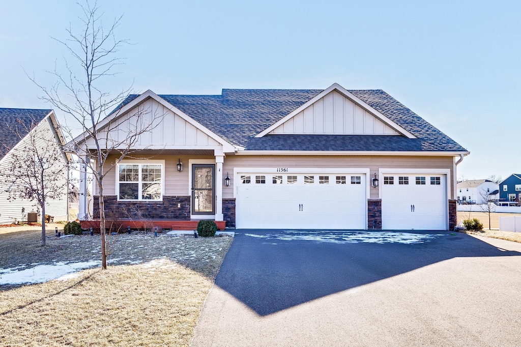 craftsman-style home with a garage and central AC