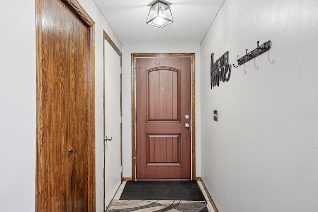 doorway featuring a textured ceiling