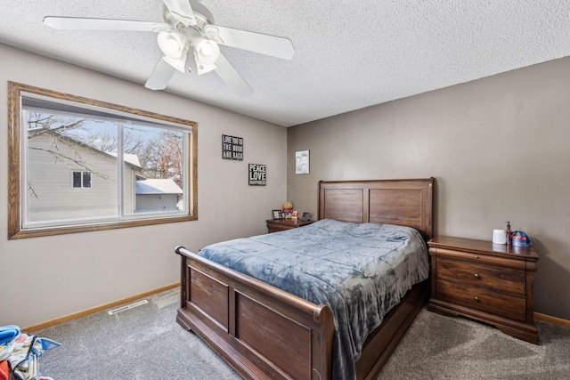 bedroom featuring ceiling fan, a textured ceiling, and carpet flooring