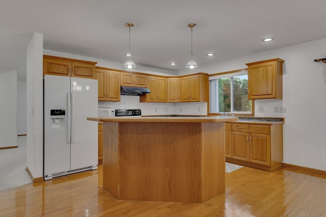 kitchen with pendant lighting, a center island, light wood-type flooring, and white fridge with ice dispenser