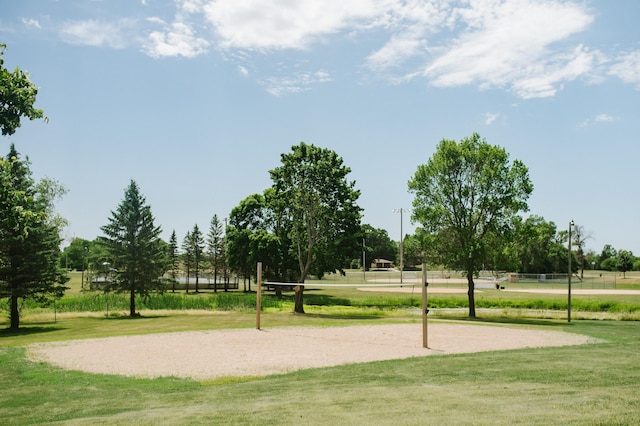 surrounding community with a lawn and volleyball court