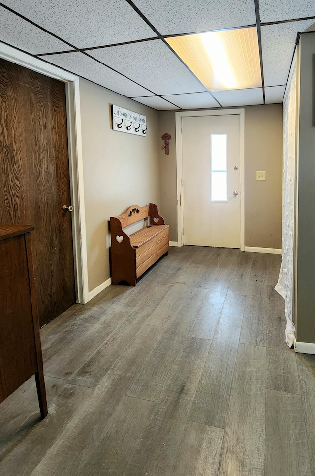 unfurnished room featuring hardwood / wood-style flooring and a drop ceiling