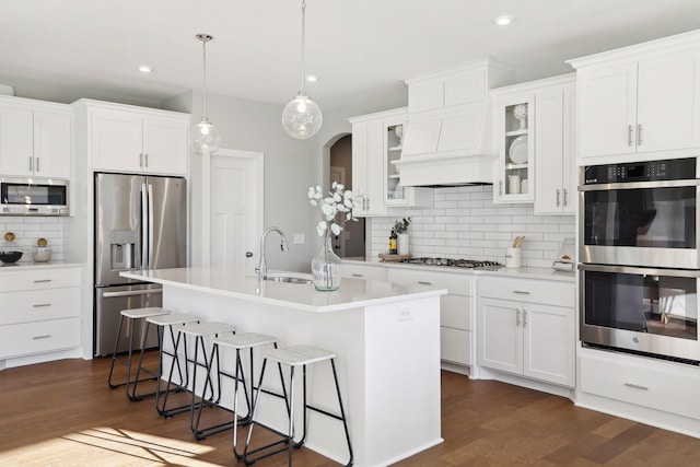 kitchen featuring appliances with stainless steel finishes, sink, and white cabinets