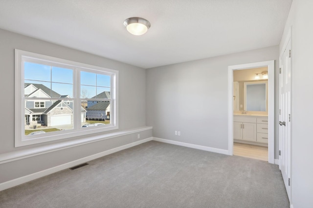 carpeted spare room with sink