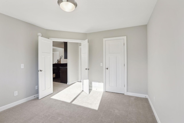 unfurnished bedroom featuring light carpet