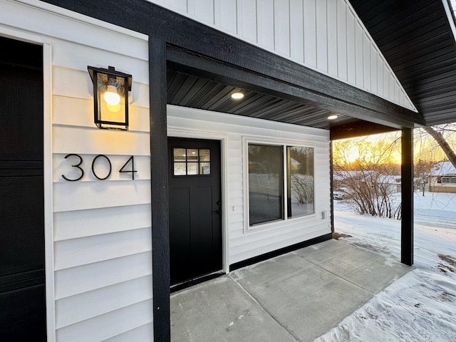 view of snow covered property entrance