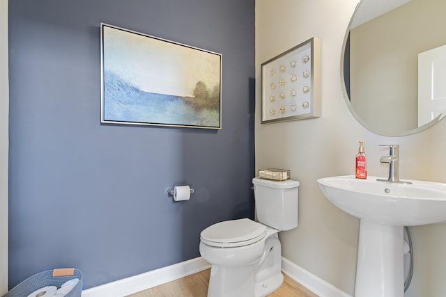 bathroom featuring sink, hardwood / wood-style flooring, and toilet