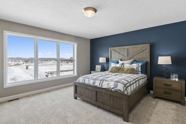 carpeted bedroom featuring a textured ceiling