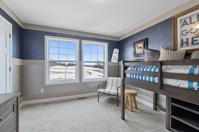 bedroom with carpet floors and a textured ceiling