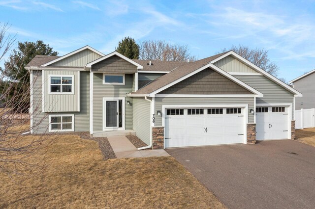 view of front of property featuring fence, a garage, and driveway