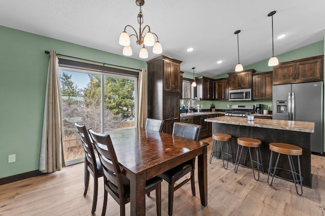 dining space featuring recessed lighting, light wood-type flooring, baseboards, and vaulted ceiling