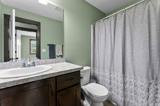 bathroom featuring visible vents, toilet, vanity, and a shower with curtain