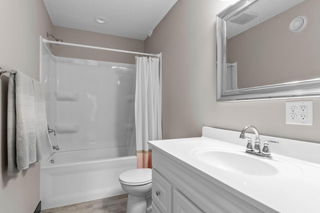 full bathroom with toilet, vanity, wood finished floors, a textured ceiling, and shower / bathtub combination with curtain