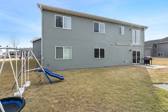 rear view of house with a yard and a patio area