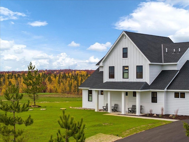 view of front of home with a patio and a front lawn