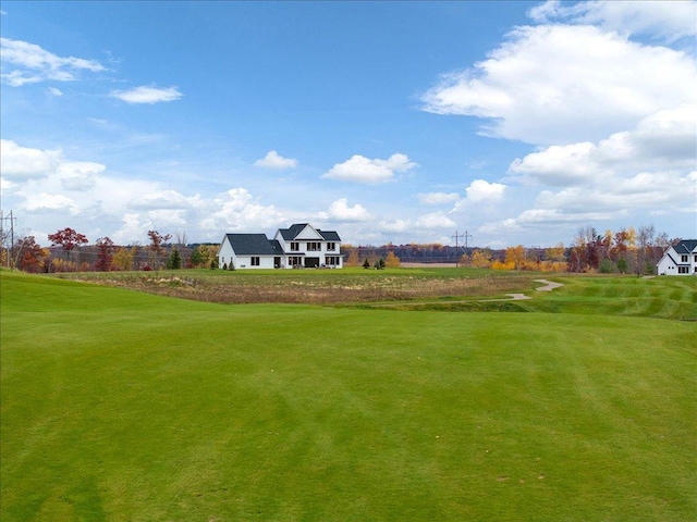 view of property's community featuring a yard