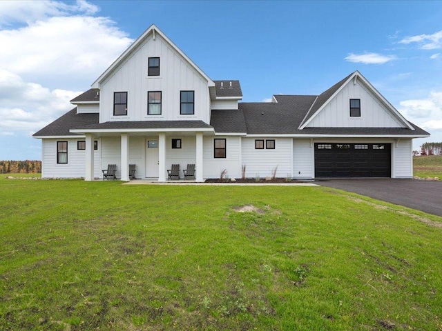 modern farmhouse style home with a garage, a porch, and a front lawn